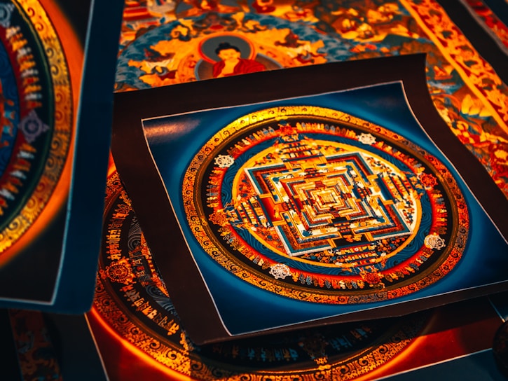 Handcrafted colorful mandalas displayed on a rustic wooden table.