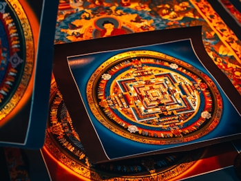 A collection of intricate, colorful mandala artworks, featuring symmetrical geometric patterns with vibrant hues of red, blue, and gold. Each piece displays a complex design, evoking a sense of spiritual and artistic expression.
