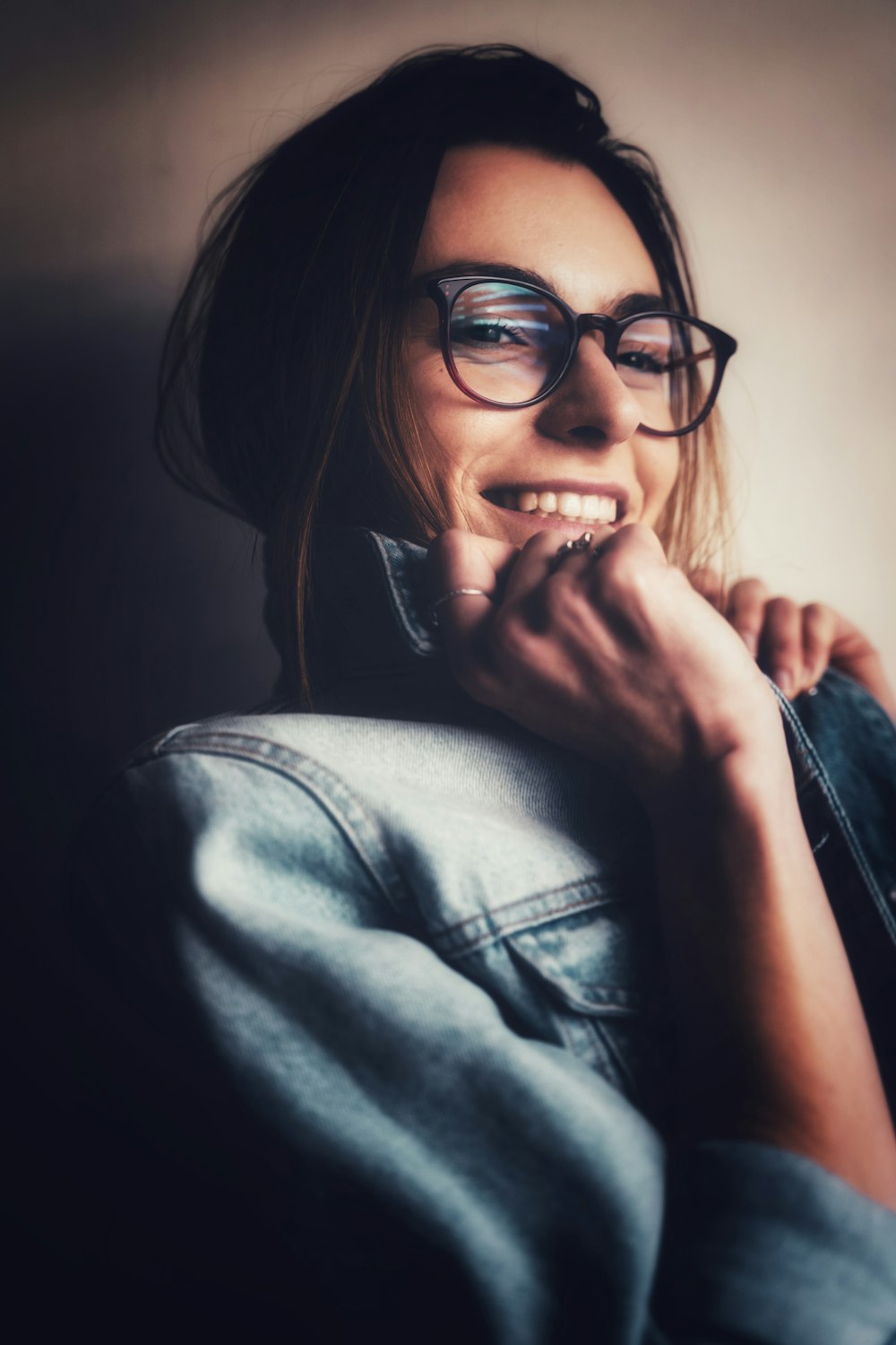 woman in black framed eyeglasses and blue denim jacket