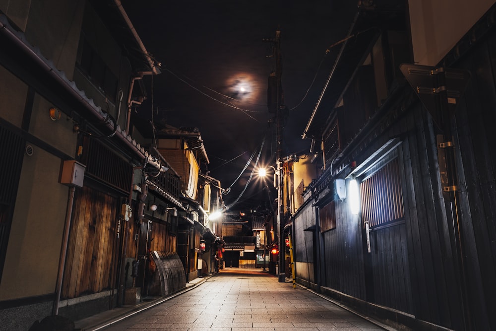 empty street with lighted light posts during night time