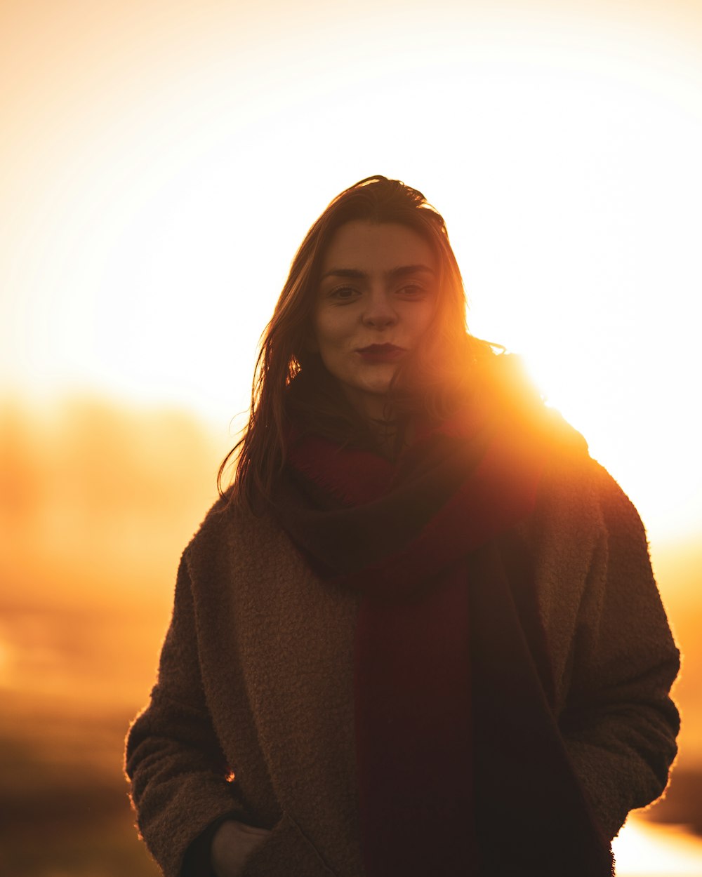 woman in black sweater standing during sunset