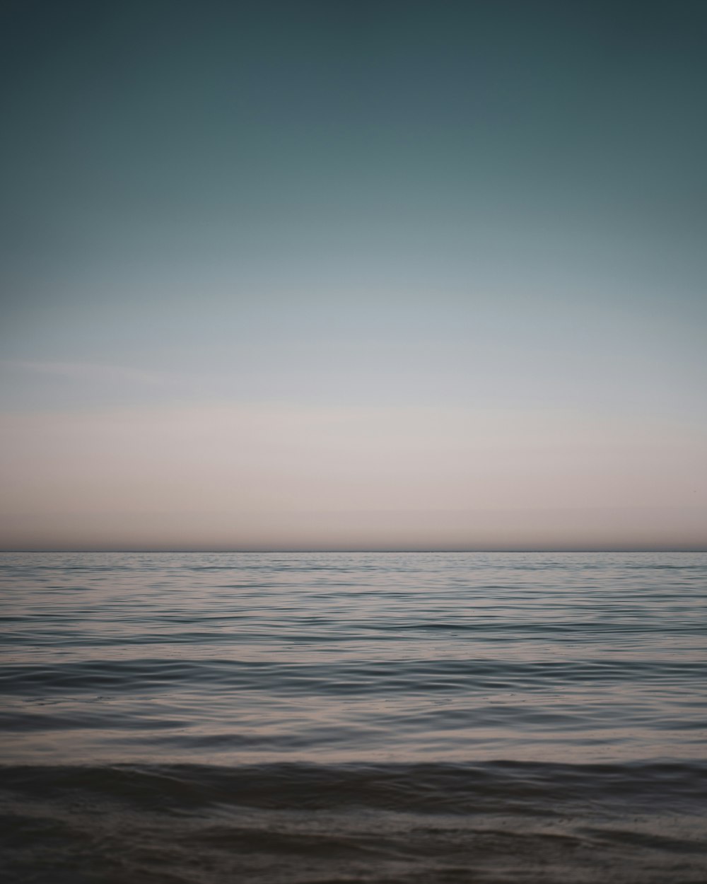 body of water under blue sky during daytime