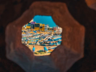 Bustling port of Tripoli with fishing boats and cargo ships against a Mediterranean backdrop.