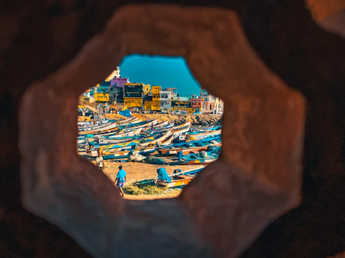 Bustling port of Tripoli with fishing boats and cargo ships against a Mediterranean backdrop.