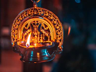Traditional brass temple lamp lit with a steady flame fueled by Shree Aradhana Pooja Oil.