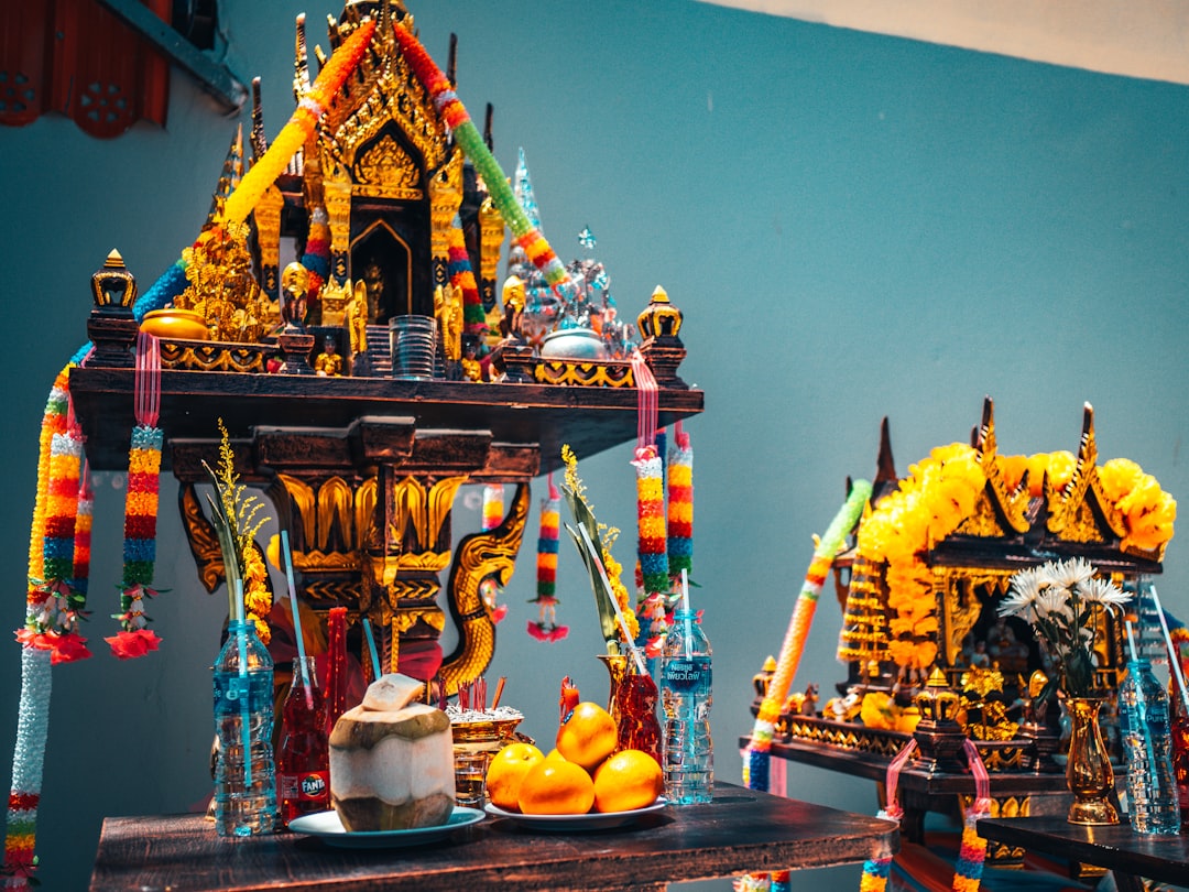 yellow and red temple with yellow fruits on top