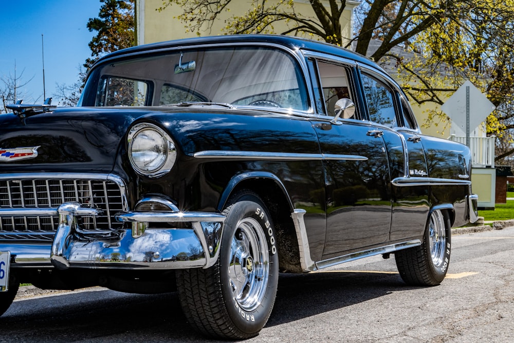 black classic car on gray concrete pavement