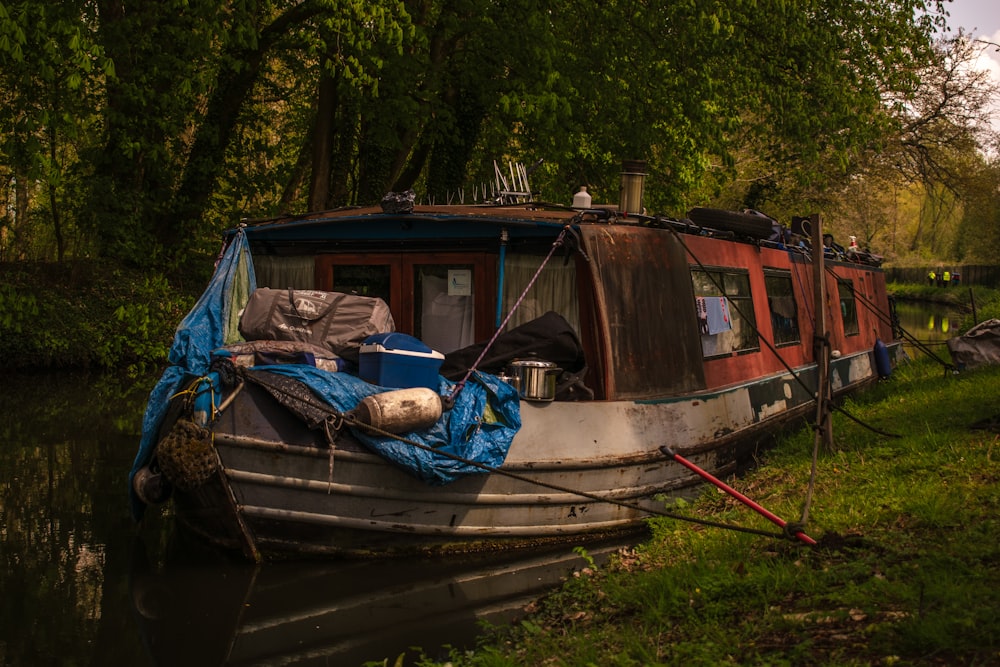 brown and white wooden boat on green grass during daytime