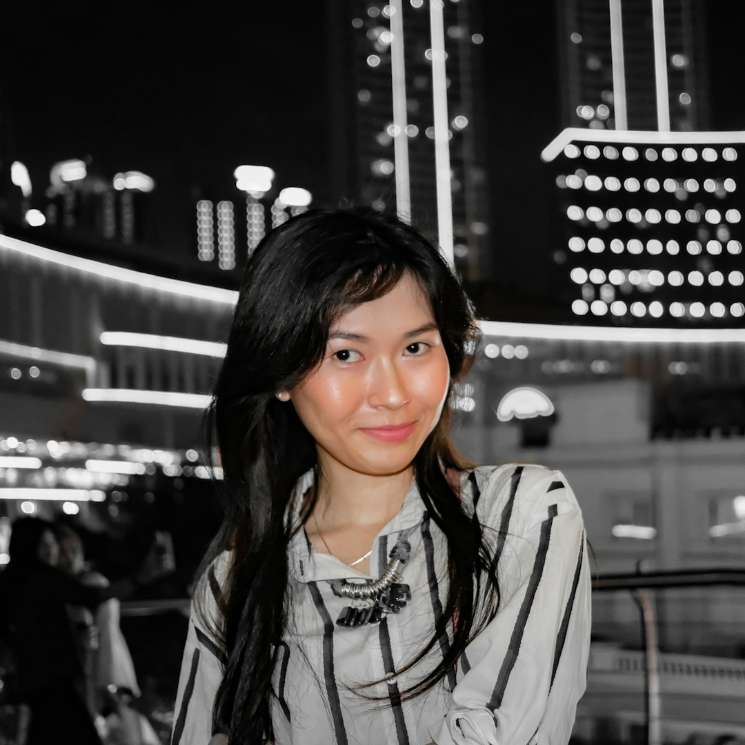 woman in white and black zip up jacket smiling