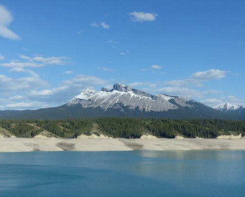 Snow covered mountain near lake under blue sky during daytime — Banff & the Rockies, Canada