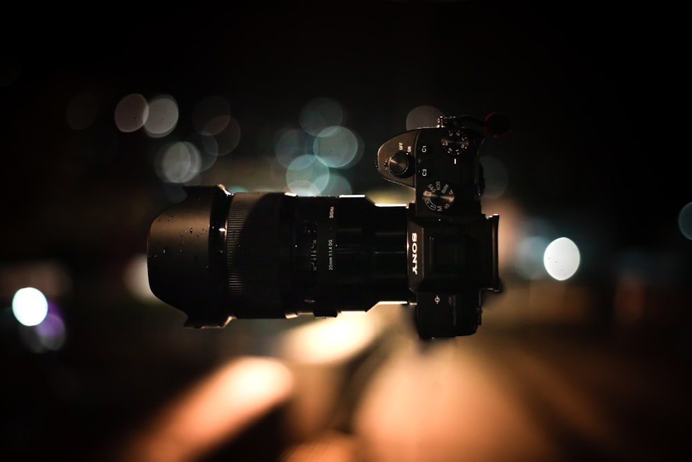 black dslr camera with bokeh lights