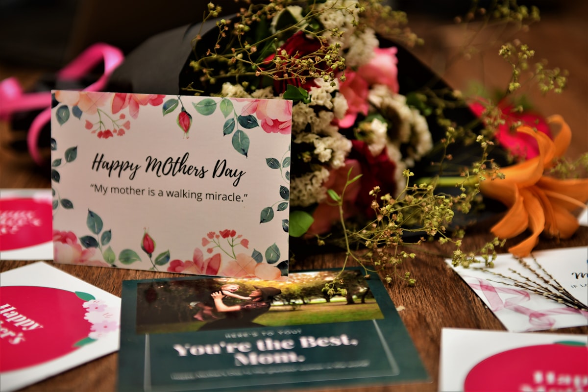 Thoughtful Mother's Day gifts arranged on a warm wooden table