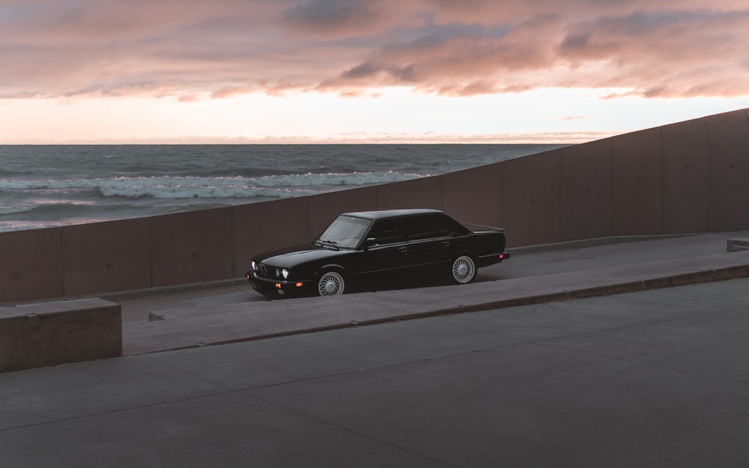 black coupe on gray asphalt road during daytime