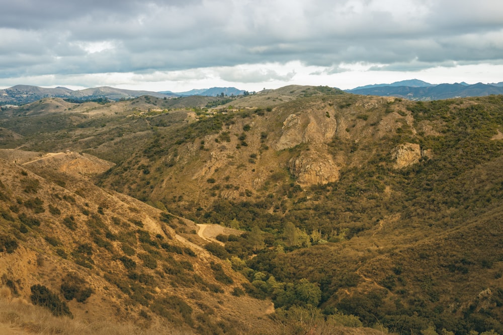 green and brown mountains under white clouds during daytime