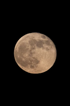 A detailed close-up of a lunar rover exploring the moon’s surface under a dark sky.