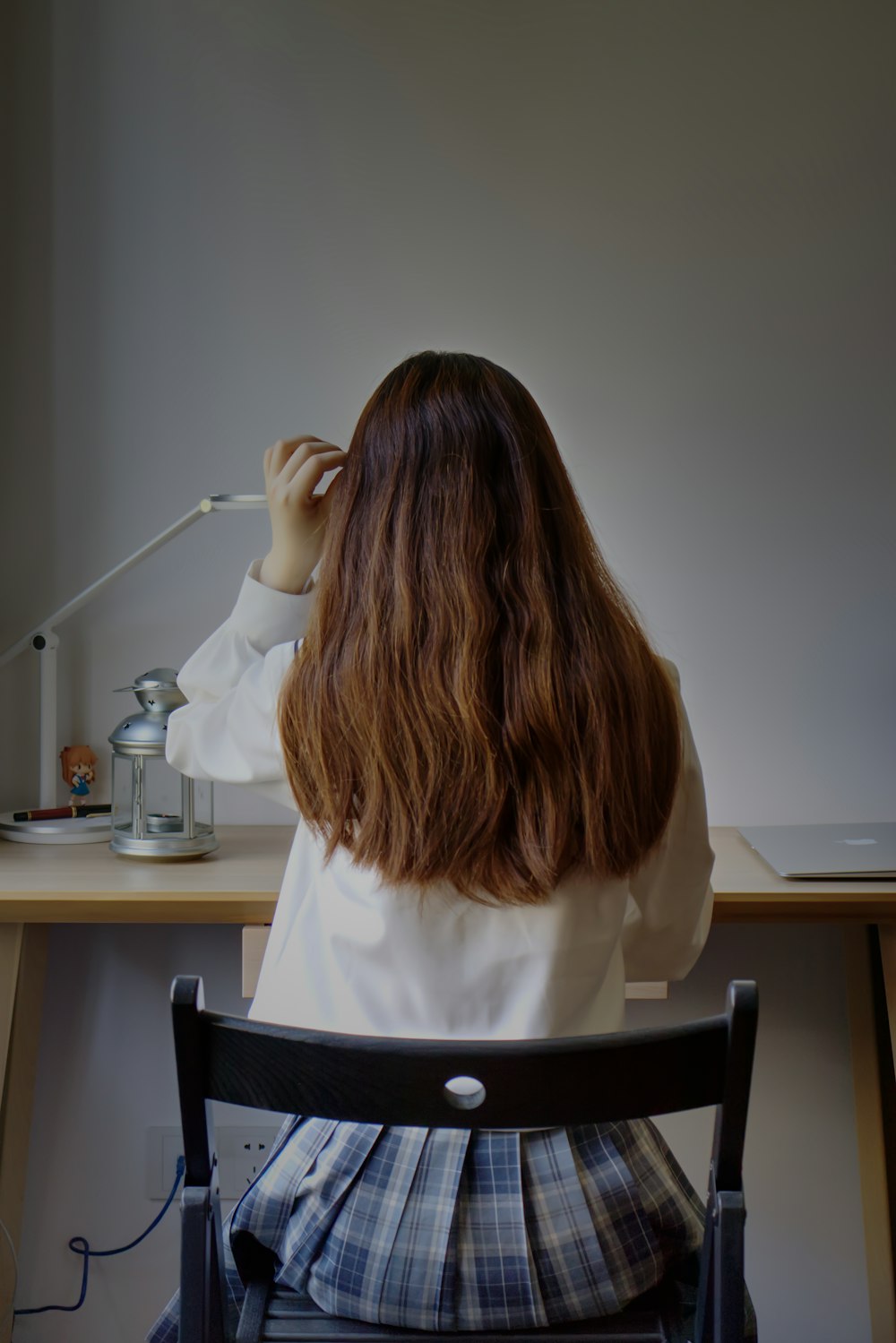 woman in white long sleeve shirt sitting on black chair