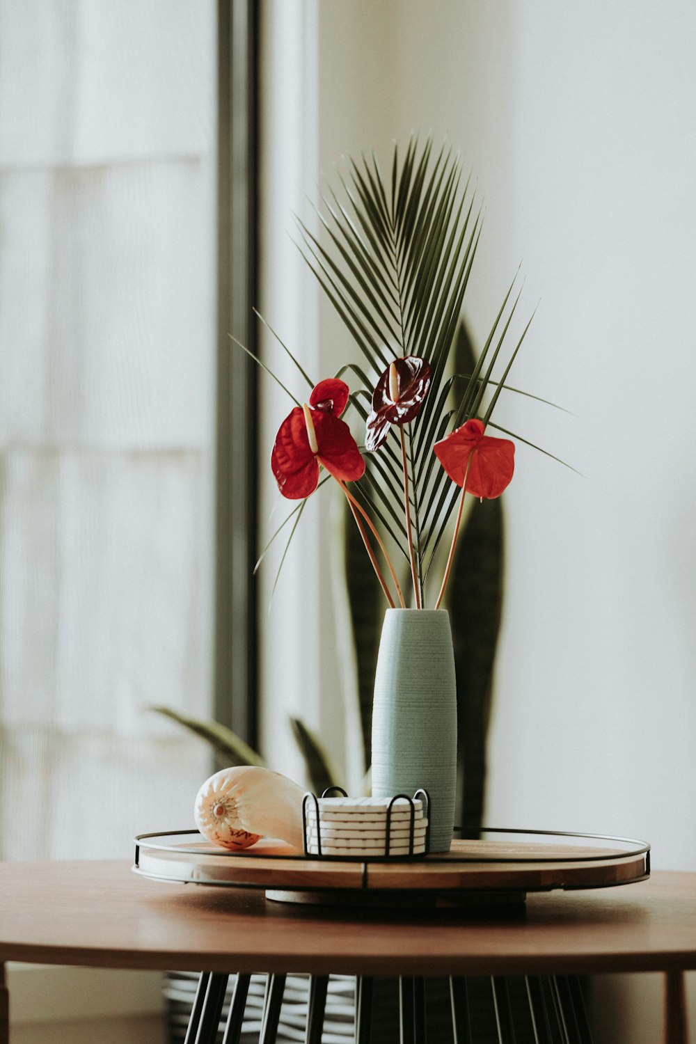 red flowers in vase on table