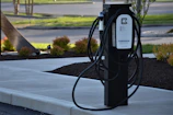 Professional installation scene of a public charging station with dual cables in an urban setting