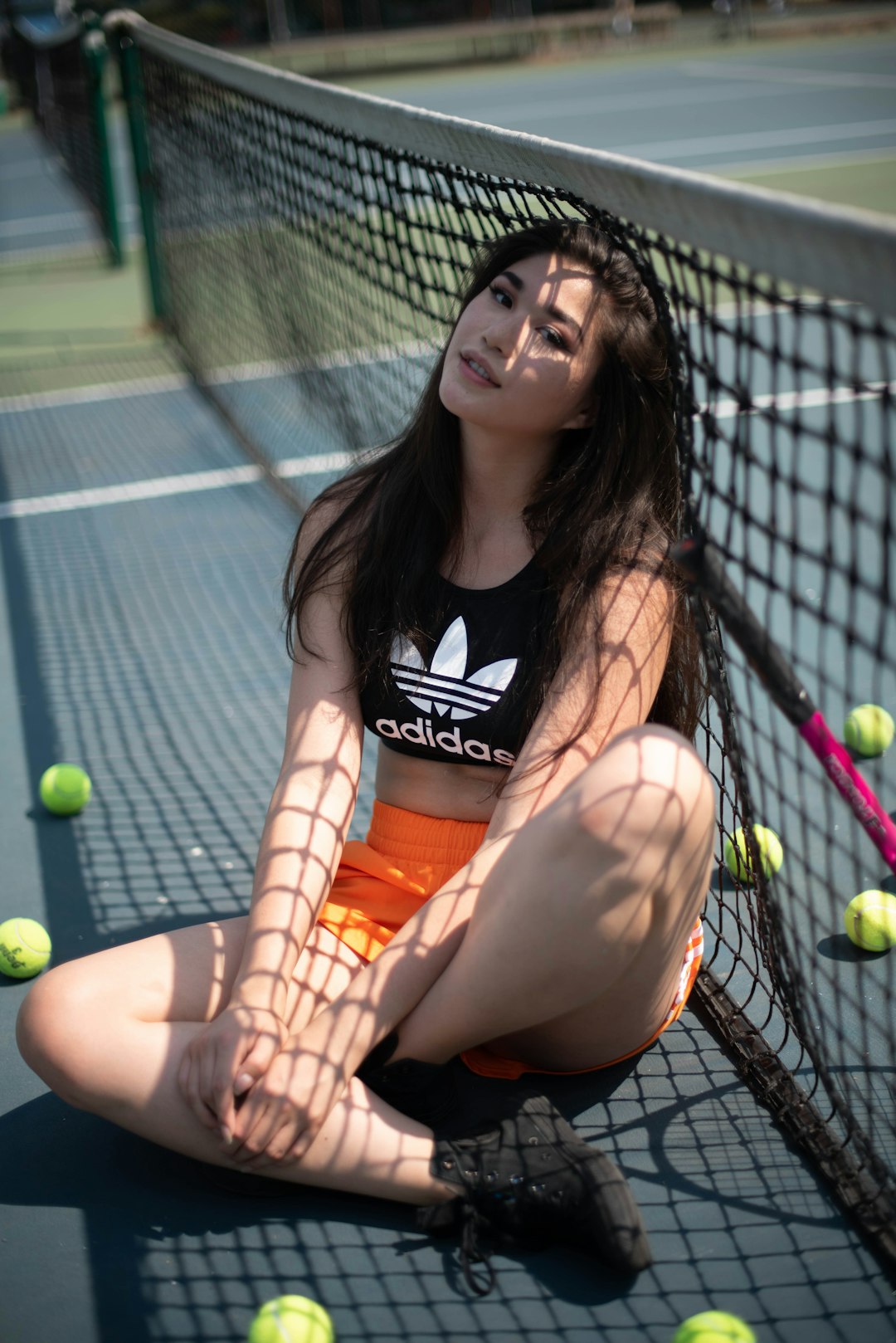 woman in black and white tank top sitting on black net