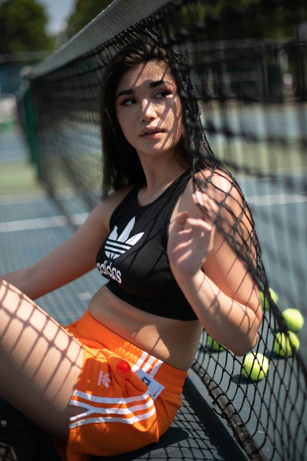 woman in black and white nike tank top and orange shorts
