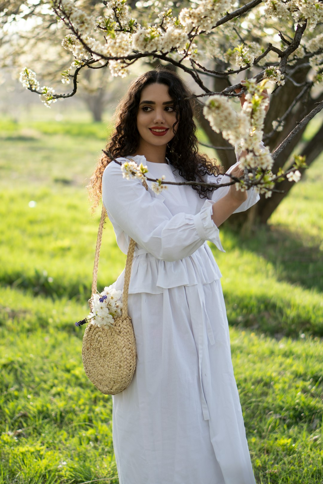 woman in white dress holding white flowers