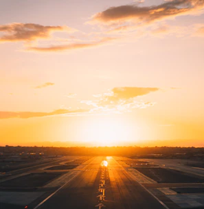 Airfield lighting glowing softly along a runway as twilight sets in.