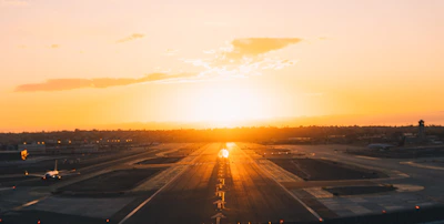 A scenic view of a UK airport runway at sunset, ready for takeoff.
