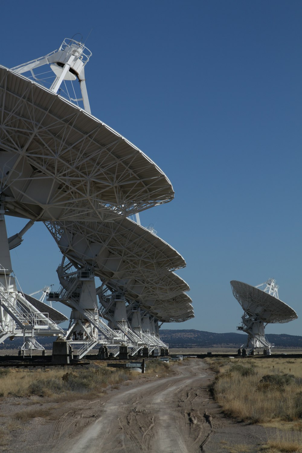 white satellite dish on green grass field during daytime