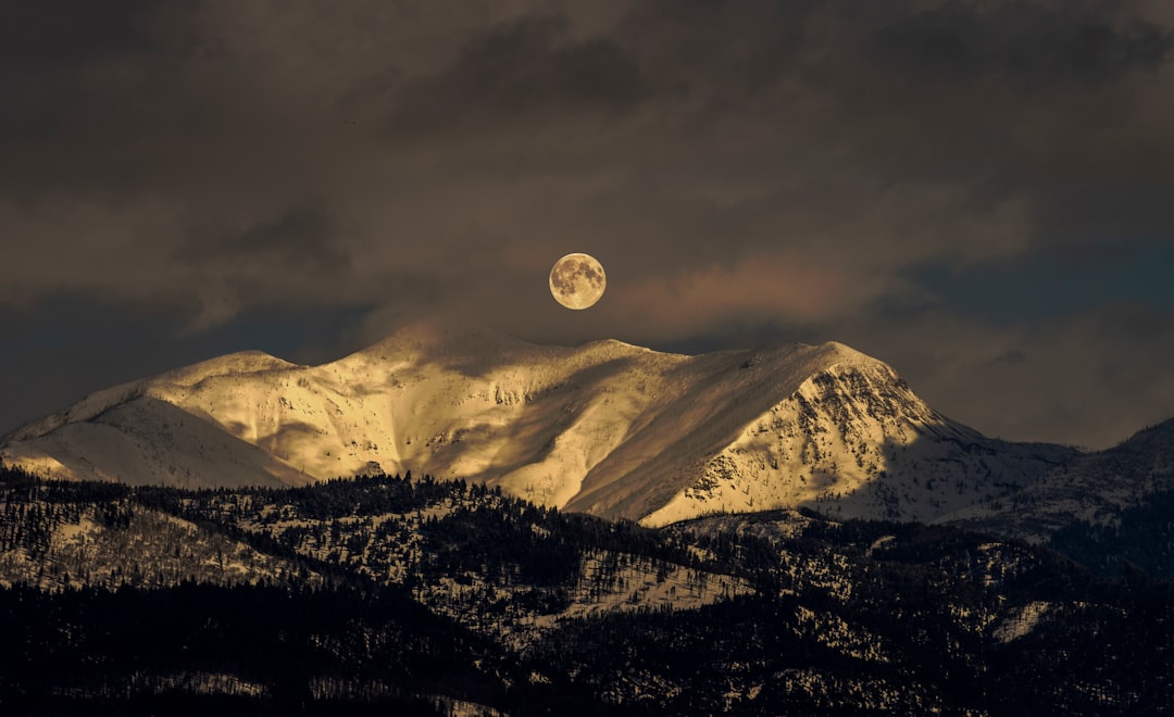 snow covered mountain under full moon