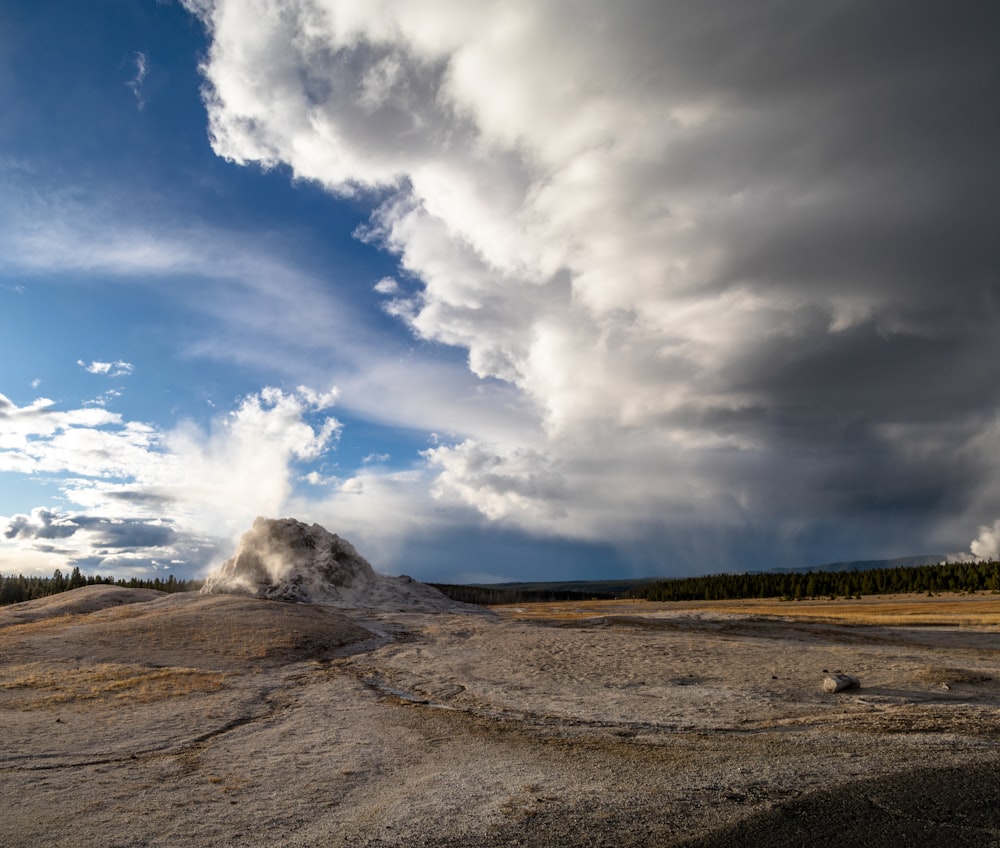 white clouds over brown field