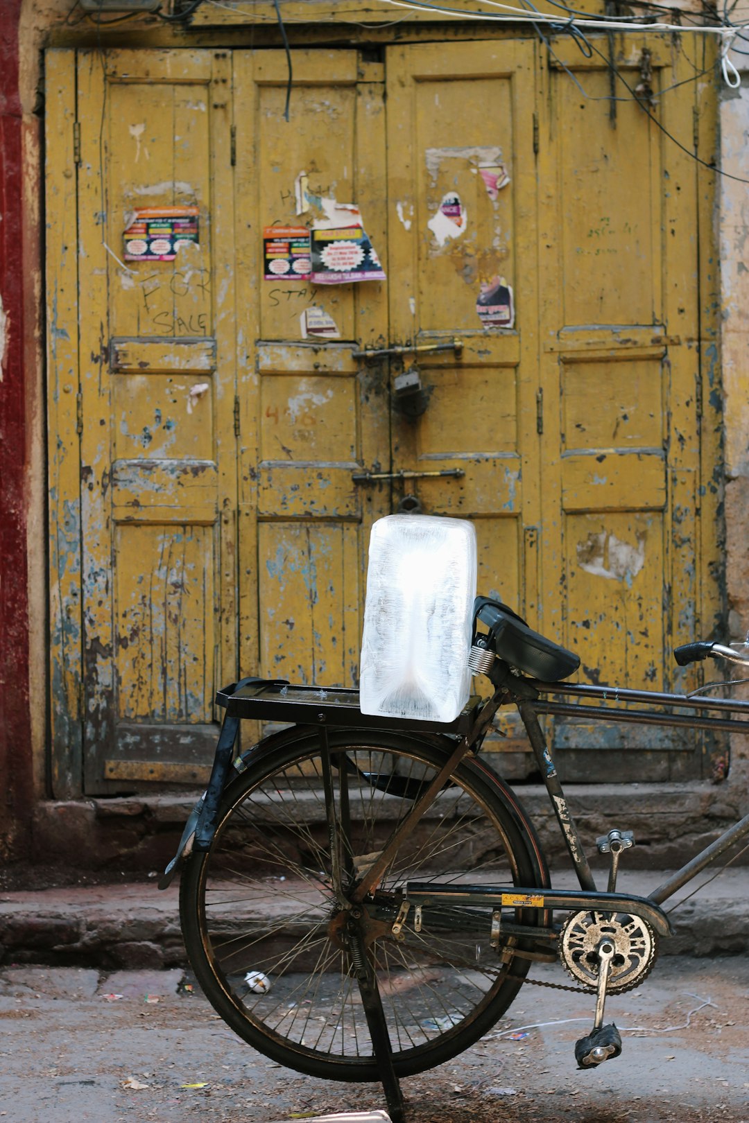 black city bike with white plastic container on top