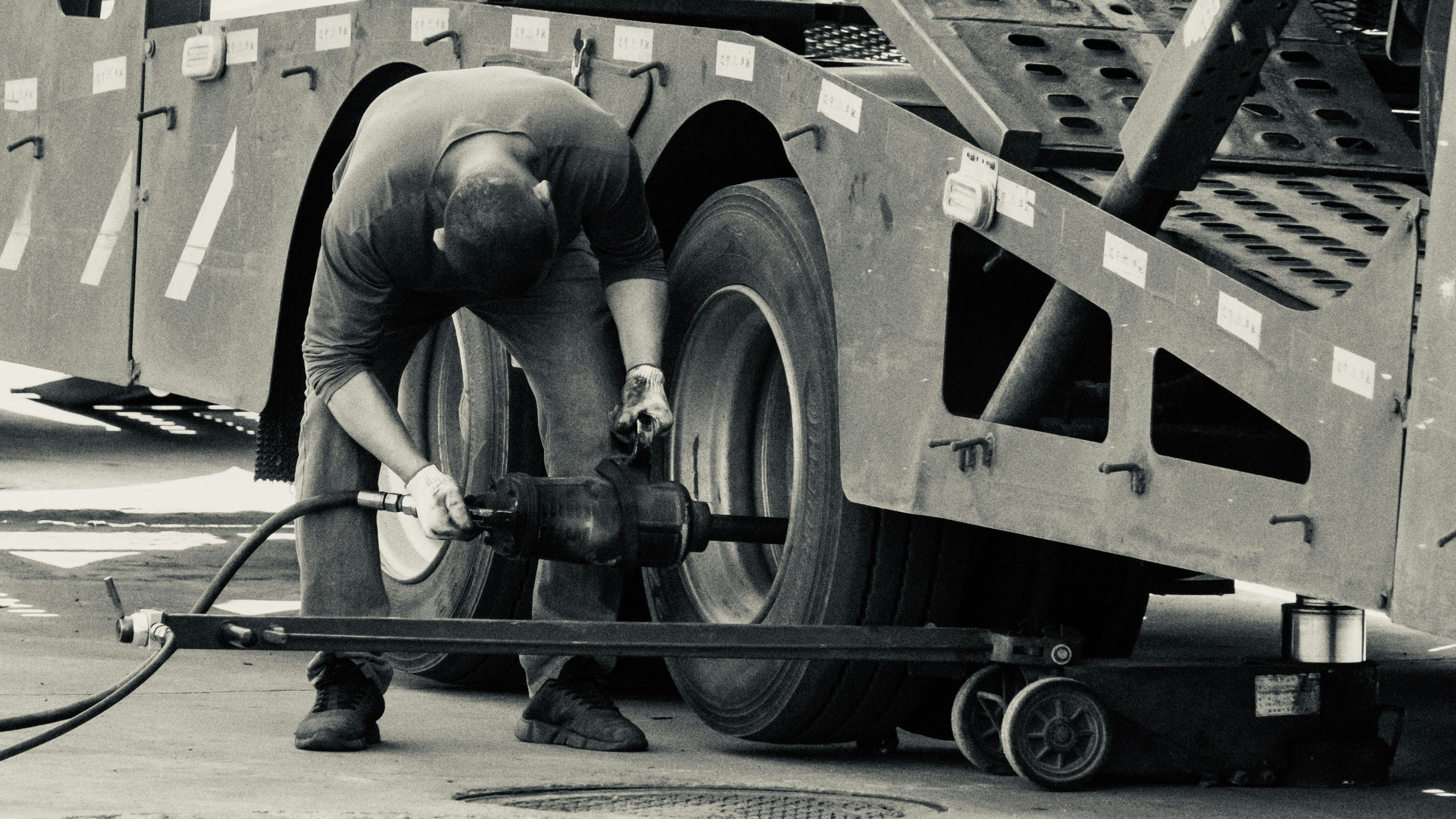 man in black t-shirt and pants holding black metal pipe