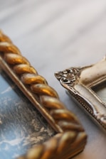 gold diamond studded ring on white textile