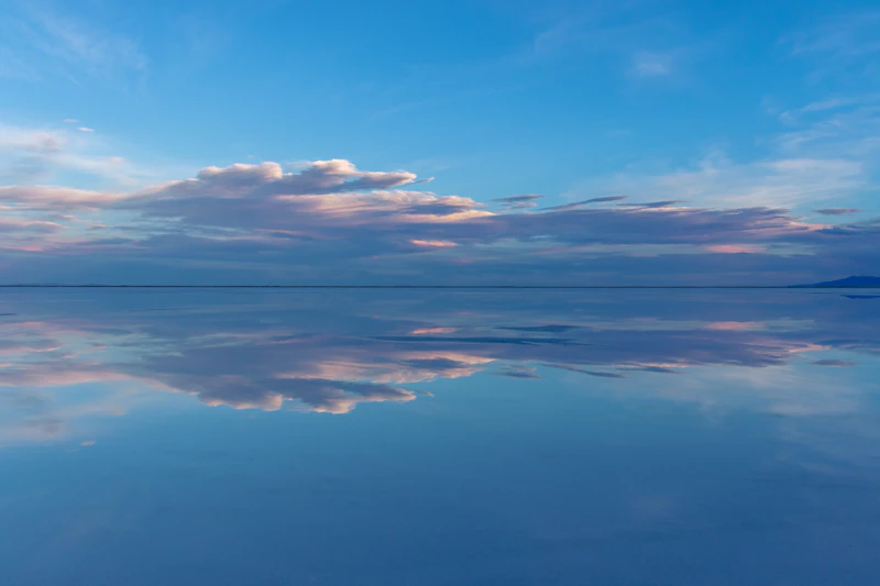 Reflective water beneath an open sky