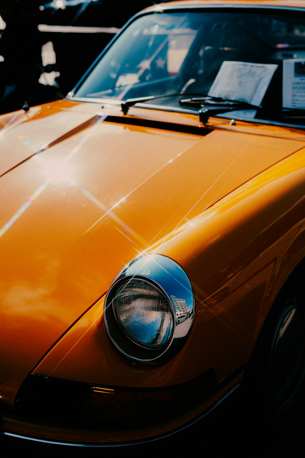 orange car with blue and silver headlight