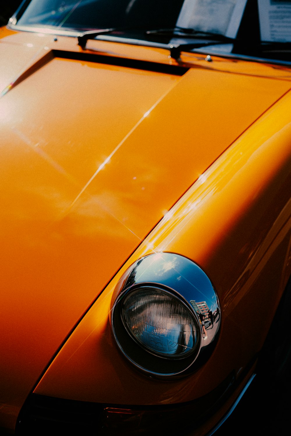 orange car with blue and silver headlight