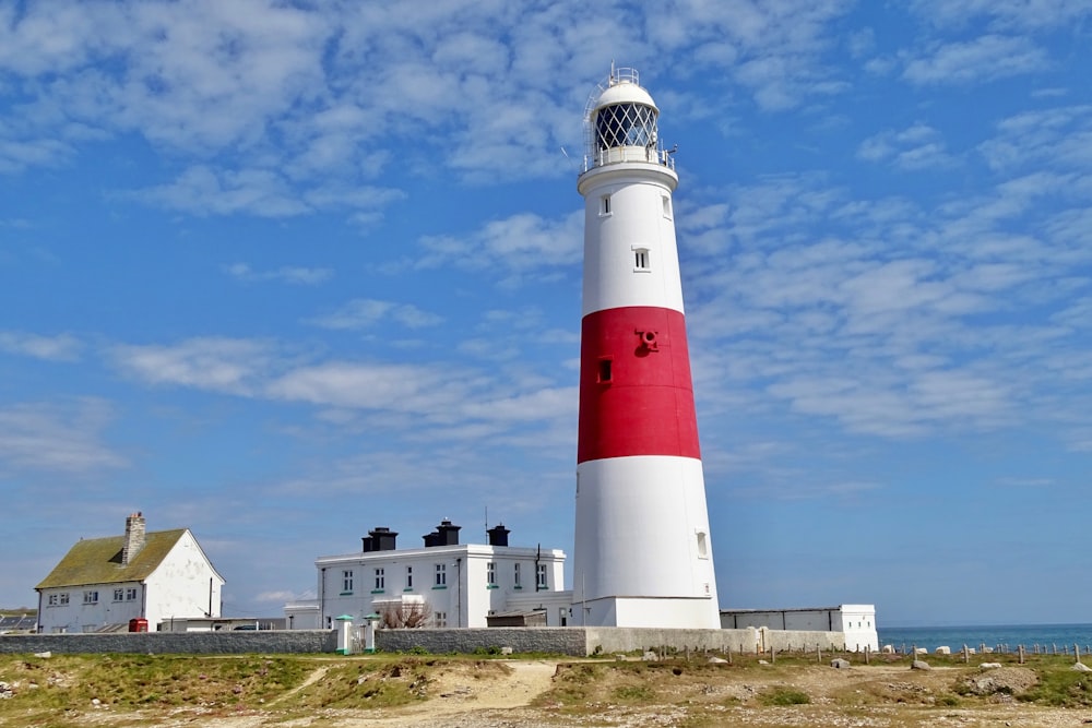 white and red lighthouse under blue sky during daytime