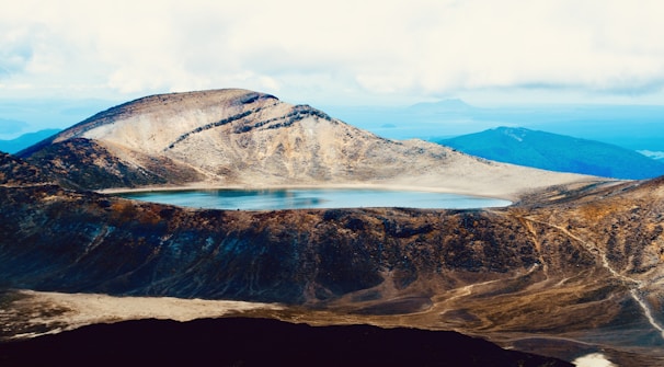A calm Segara Anak lake nestled in a volcanic crater reflecting the surrounding mountains.