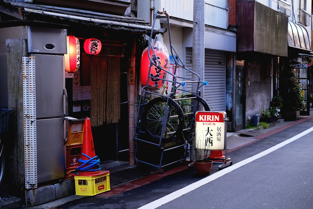 black bicycle leaning on black metal gate