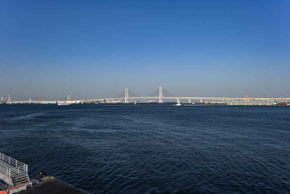 white bridge over the sea during daytime