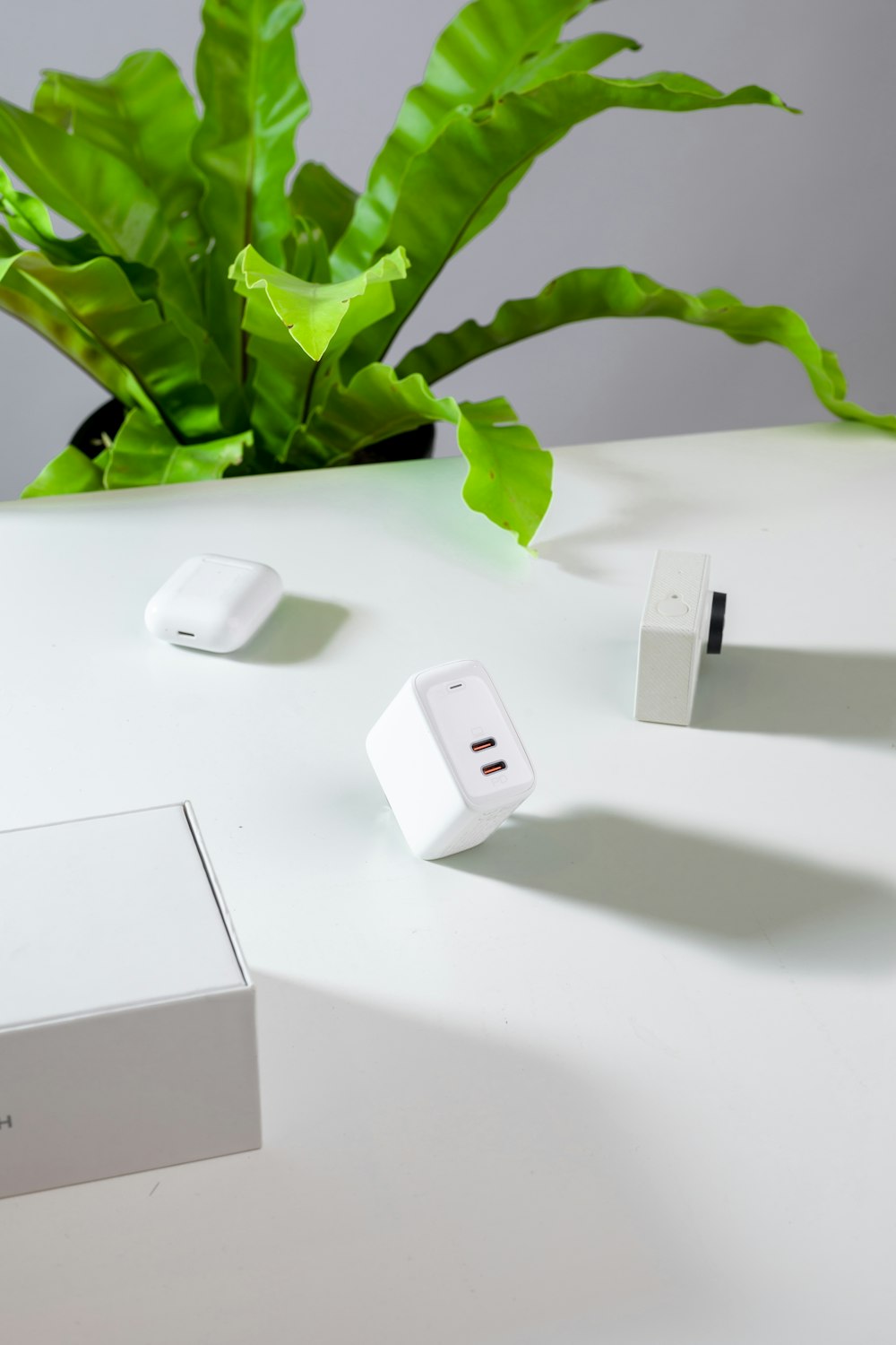 white apple charger adapter on white table