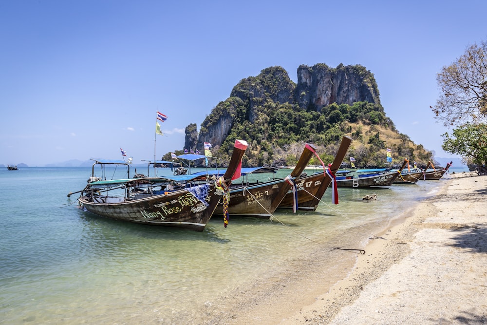 brown boat on beach during daytime