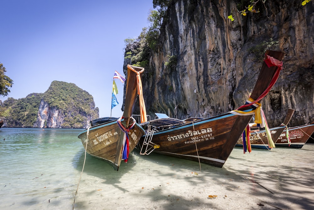 brown boat on white sand beach during daytime