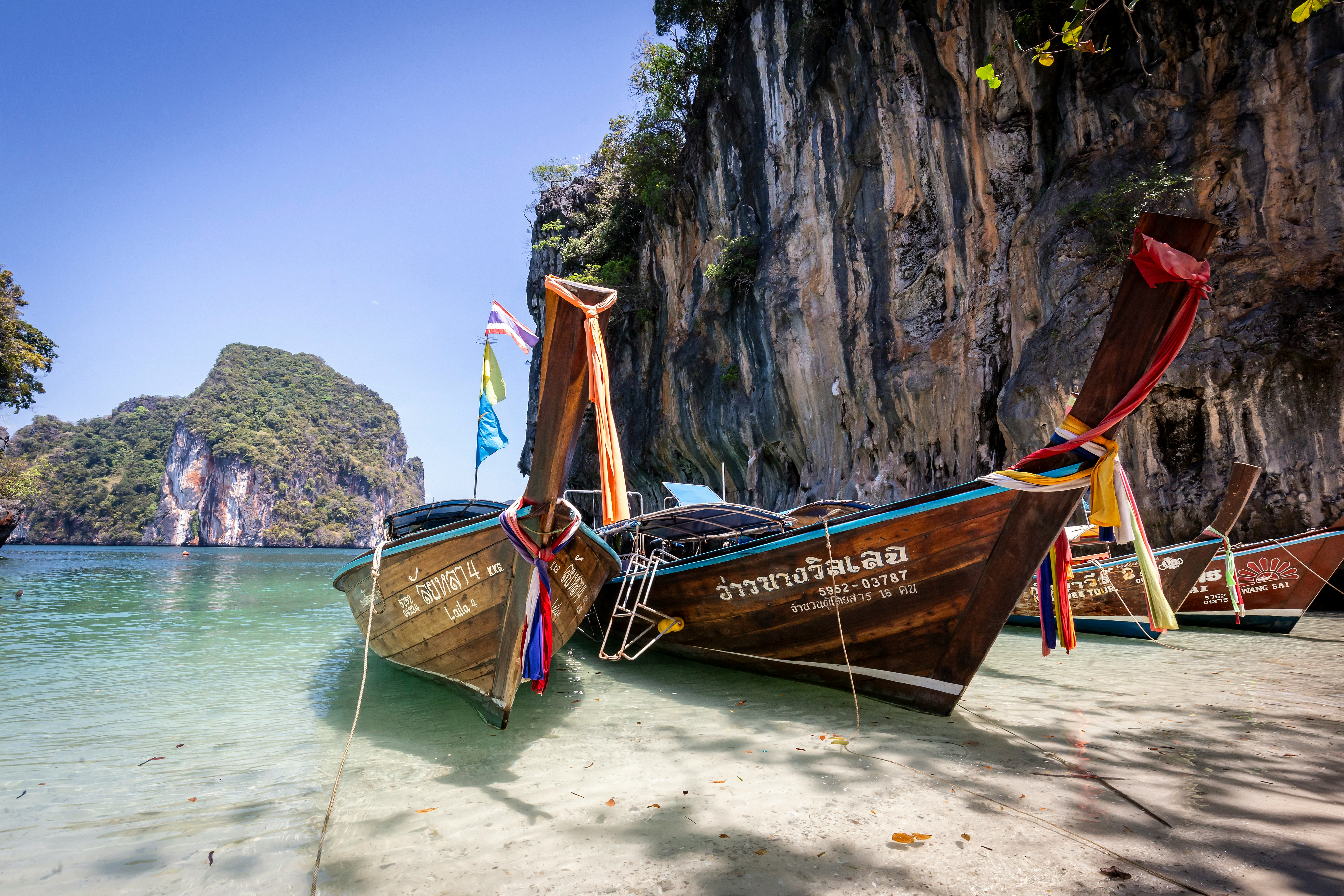 brown boat on white sand beach during daytime