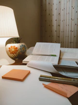 A cozy reading nook with an open book and a pen ready for notes.