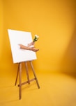 woman in white dress sitting on brown wooden seat