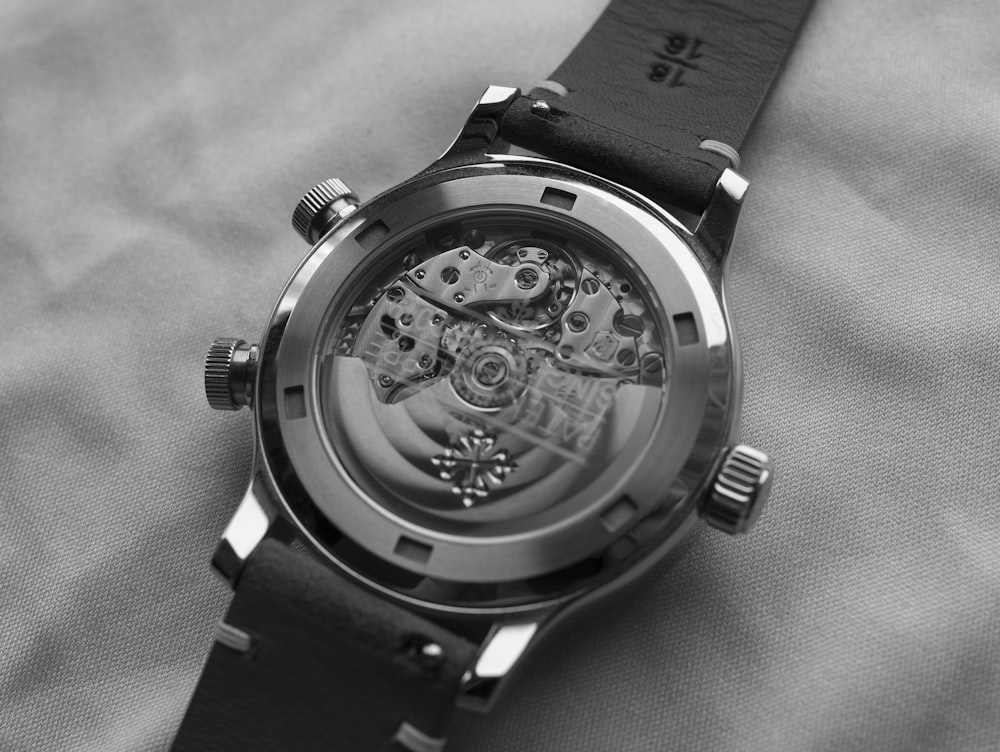 grayscale photo of round chronograph watch