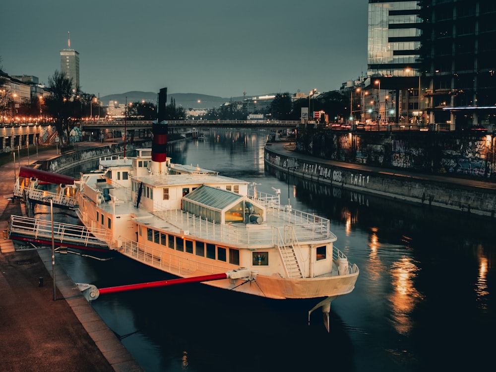 weißes und braunes Boot am Dock während der Nacht