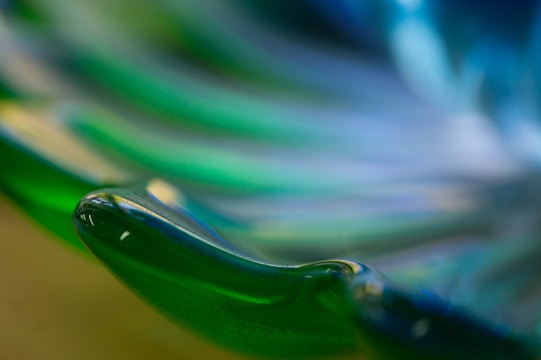 Close-up of a delicate glass sculpture with vibrant colors reflecting light.