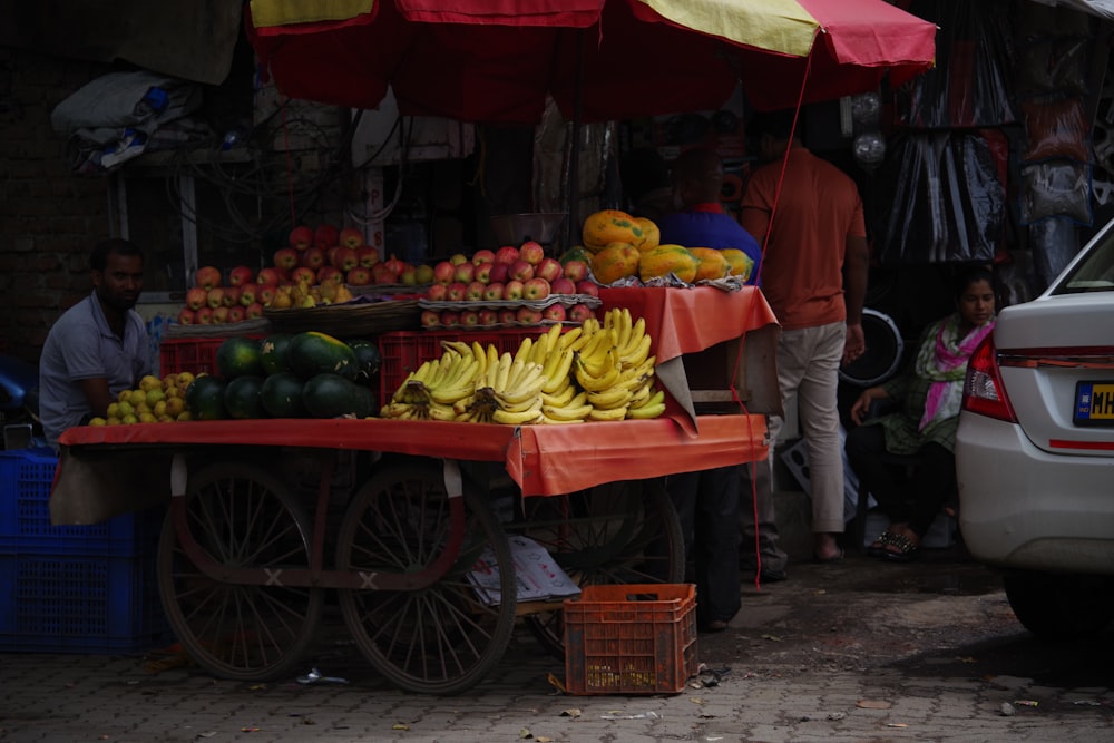 people standing near fruit stand during daytime